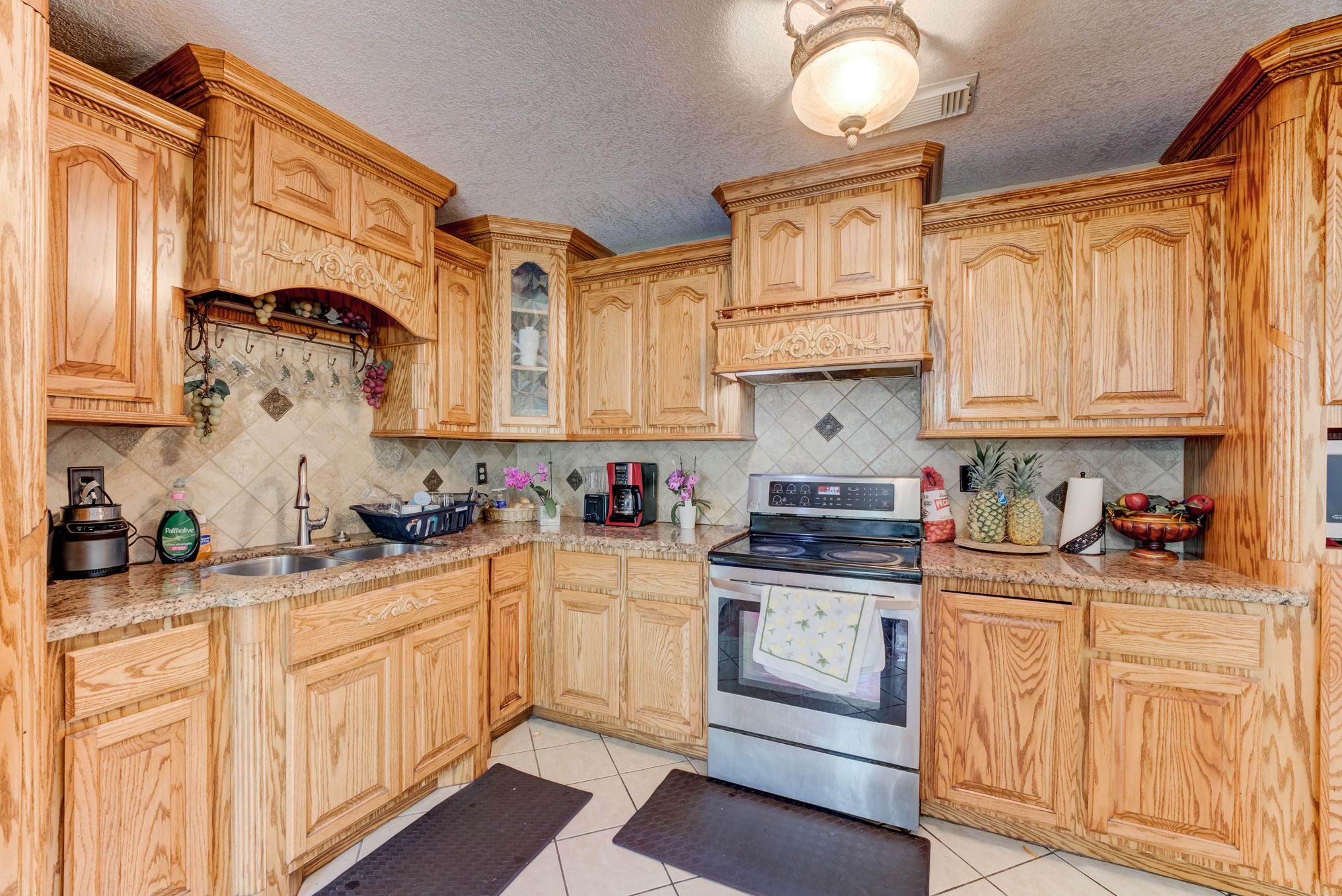 316 Hickman Lane Angleton, TX 77515 - Photo 10 of 48 a kitchen with stainless steel appliances granite countertop a stove a sink and cabinets