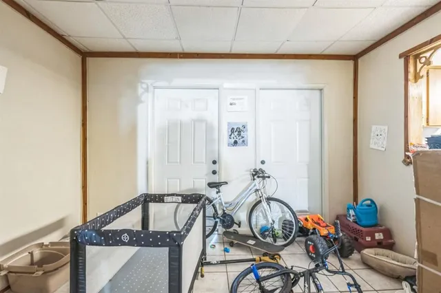 a living room with furniture a large window and a chandelier
