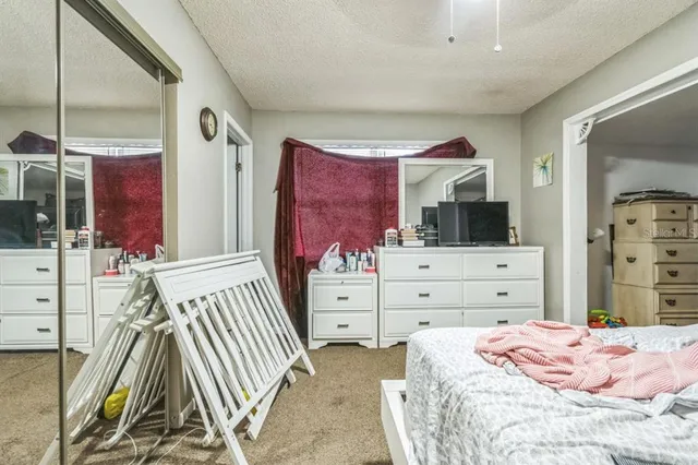 a bedroom with furniture and a window