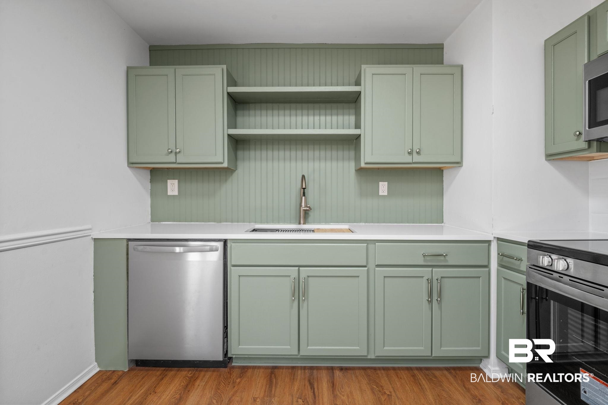 5734 Pheasant Court Theodore, AL 36582 - Photo 6 of 23 Kitchen with green cabinets, open shelves, stainless steel appliances, and dark wood-type flooring