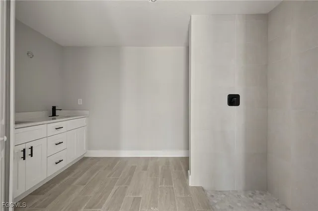 a room with white cabinets and sink