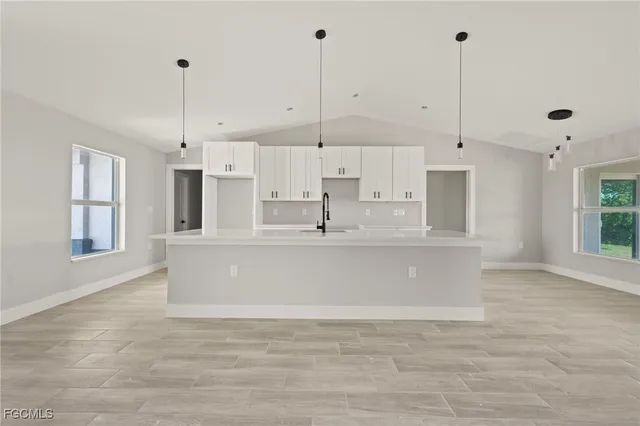 a view of large kitchen with stainless steel appliances granite countertop cabinets