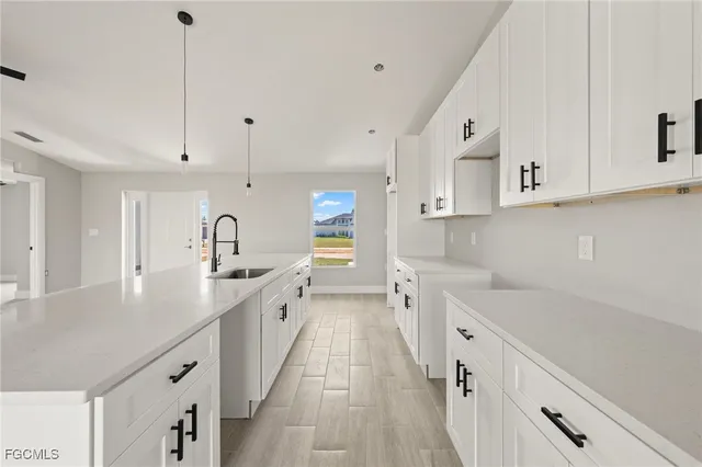 a kitchen with a sink stove and cabinets