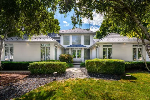 a front view of a house with a garden