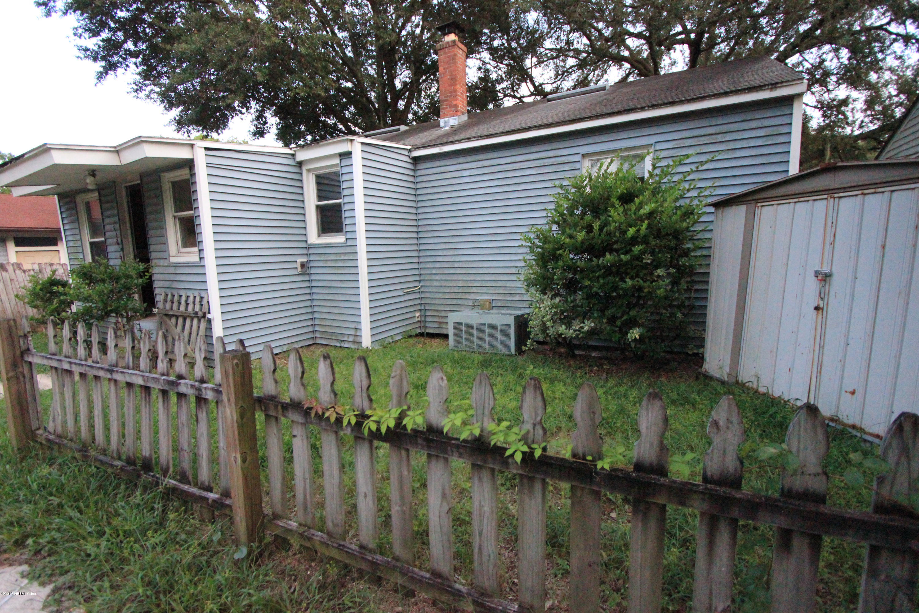 5209 Birkenhead Road Jacksonville, FL 32210 - Photo 17 of 19 a view of a house with a yard plants and wooden fence