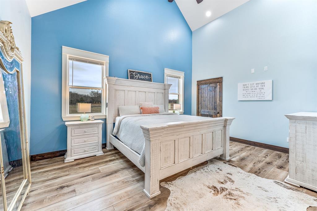 239 32507th Road Paris, TX 75460 - Photo 38 of 40 Bedroom with high vaulted ceiling and light wood finished floors