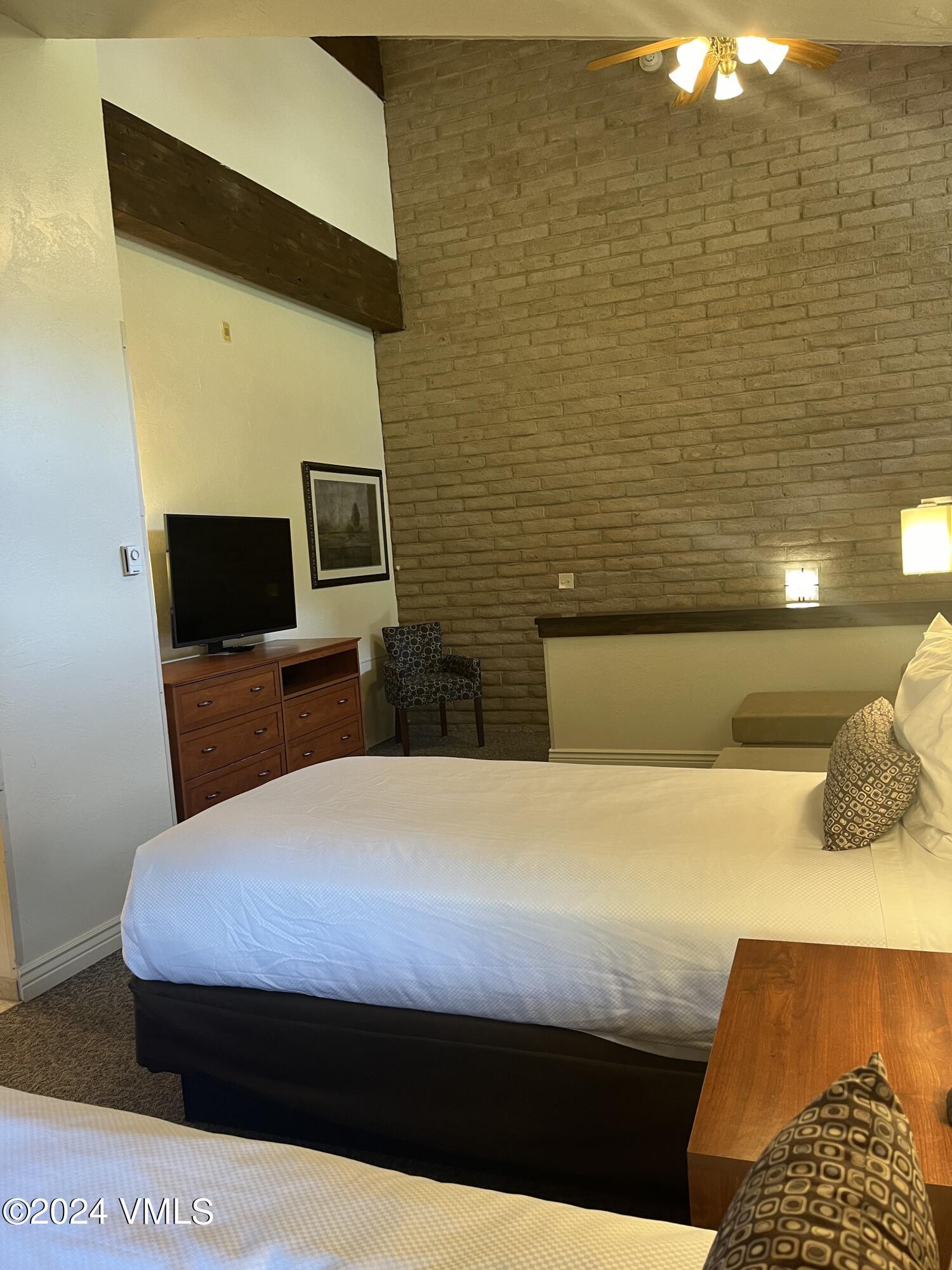 1020 Vail View Drive, Unit 340325 Vail, CO 81657 - Photo 11 of 25 a bedroom with a bed and flat screen tv