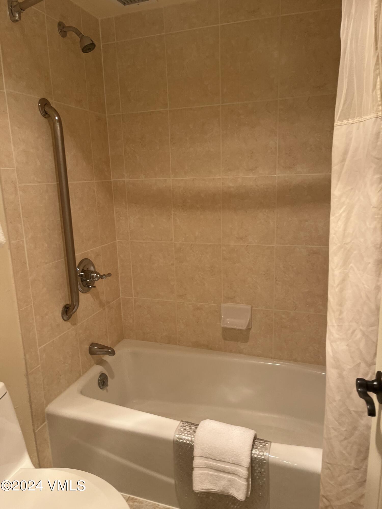 1020 Vail View Drive, Unit 340325 Vail, CO 81657 - Photo 13 of 25 a bathroom with a tub and a shower