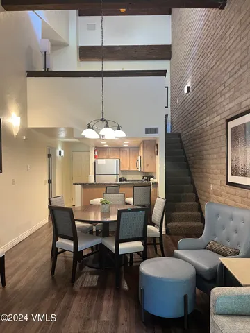 a dining room with furniture and wooden floor