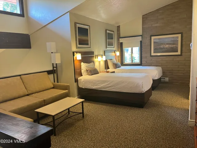 a bedroom with a bed and flat screen tv