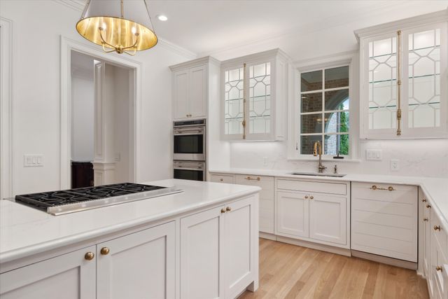 a kitchen with a sink cabinets and window