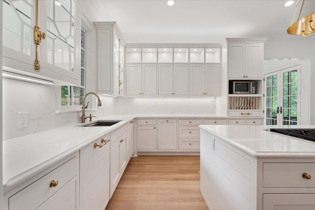 a kitchen with a sink stove and cabinets
