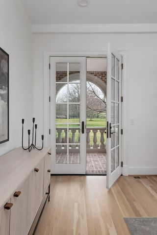 a view of a bedroom with wooden floor and windows