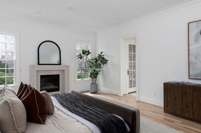 a bedroom with a bed and a fireplace