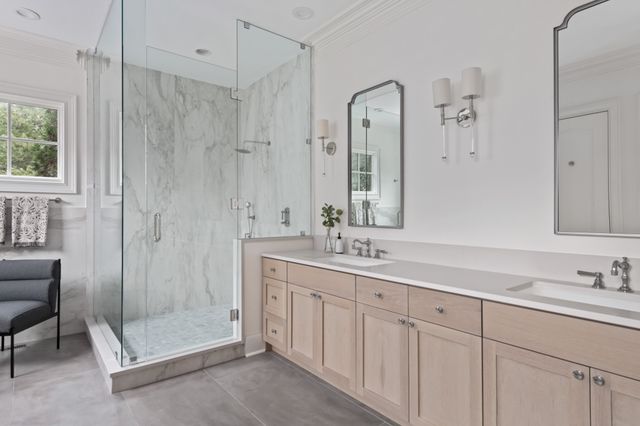a bathroom with a shower sink and mirror