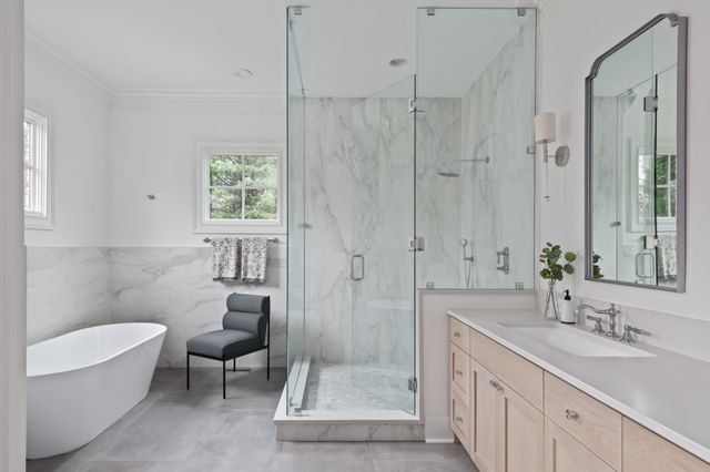 a bathroom with a sink a toilet and shower