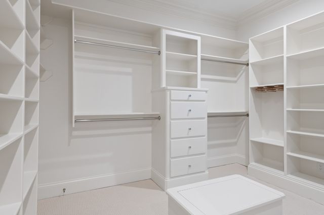 a view of walk in closet with empty racks