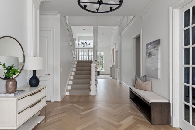 a view of an entryway with wooden floor and a livingroom view