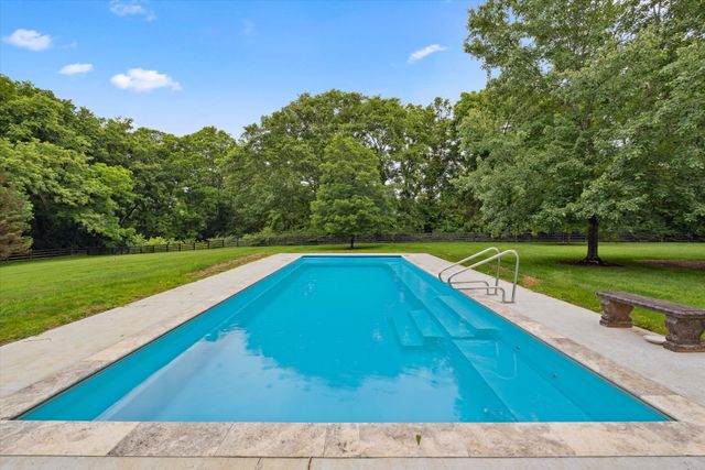 a front view of a house with a garden and plants