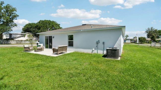 16290 Kakawi Road Weeki Wachee, FL 34614 - Photo 19 of 22 a backyard of a house with table and chairs