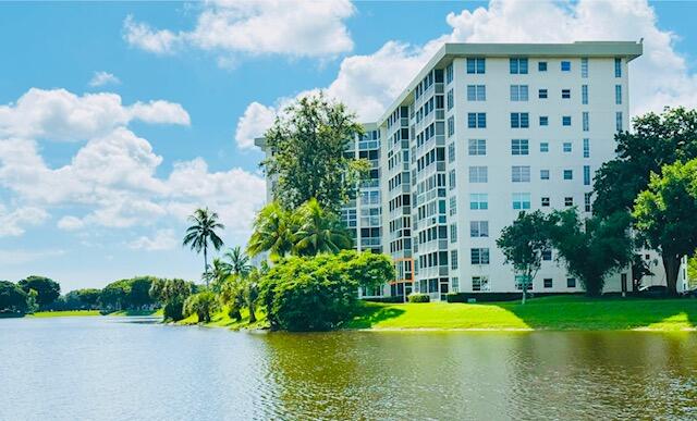 3051 North Course Drive, Unit 807 Pompano Beach, FL 33069 - Photo 1 of 24 a view of a swimming pool with a lawn chairs and plants