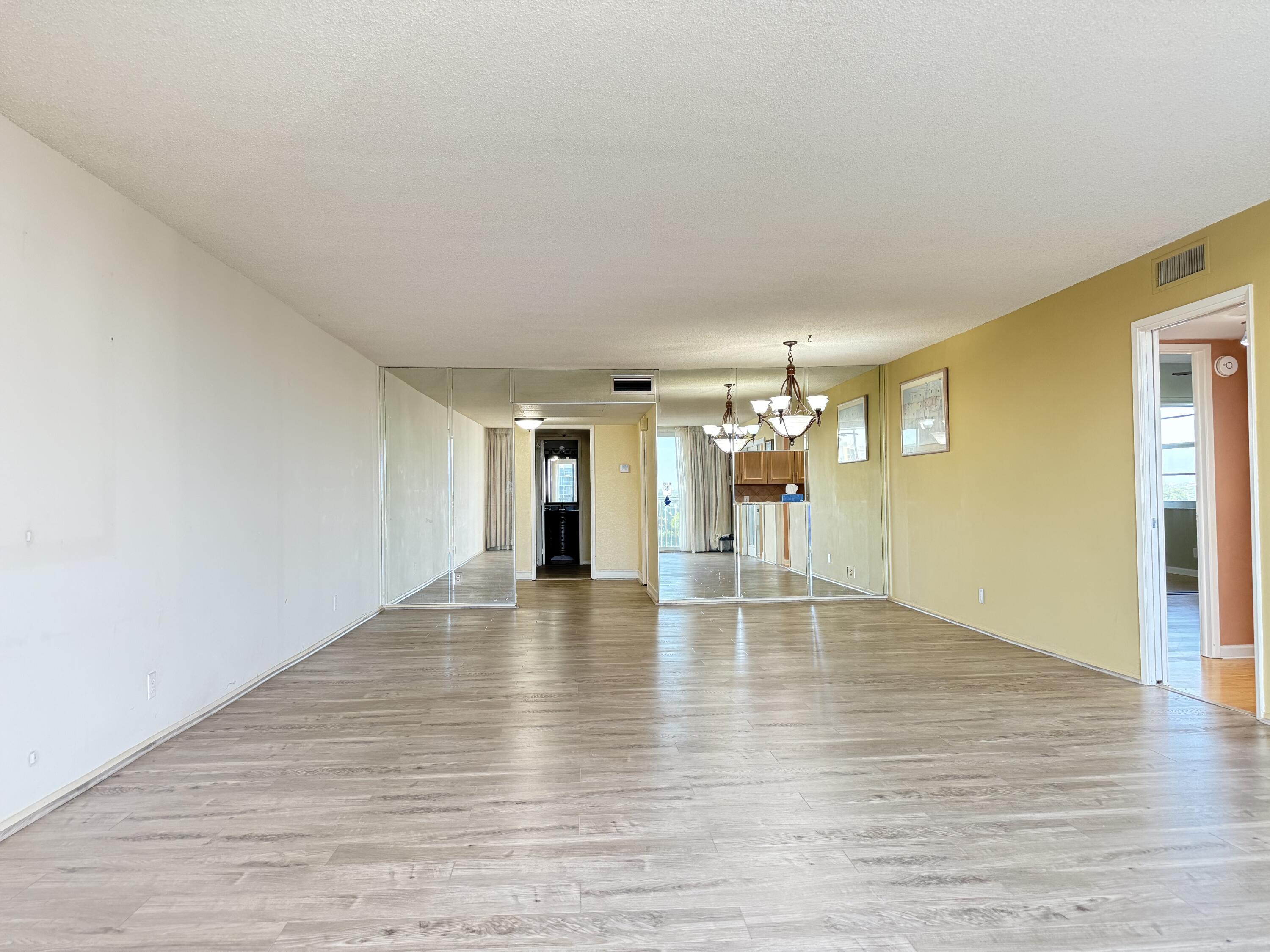 3051 North Course Drive, Unit 807 Pompano Beach, FL 33069 - Photo 7 of 24 a view of an empty room with wooden floor