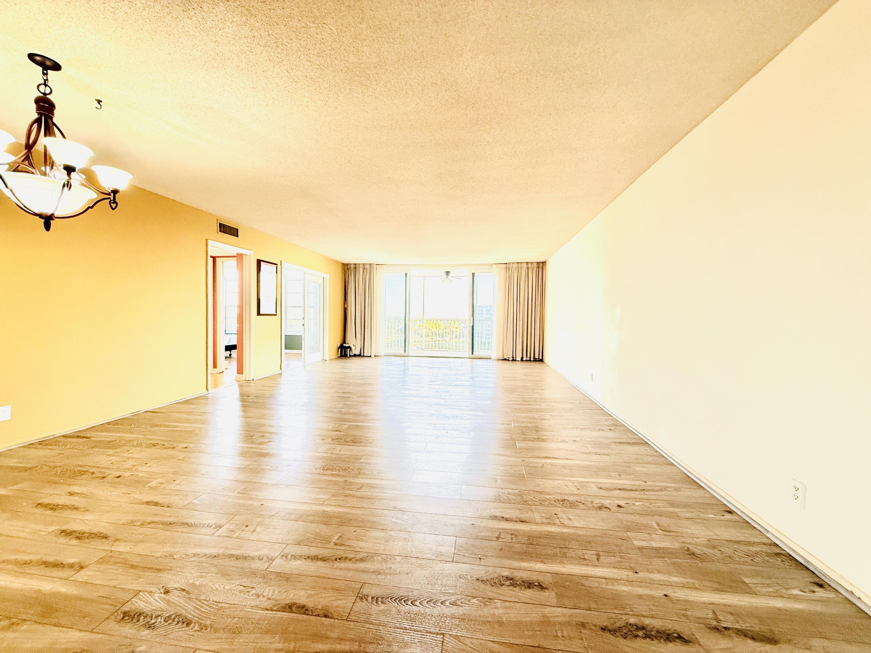 3051 North Course Drive, Unit 807 Pompano Beach, FL 33069 - Photo 8 of 24 a view of an empty room with wooden floor