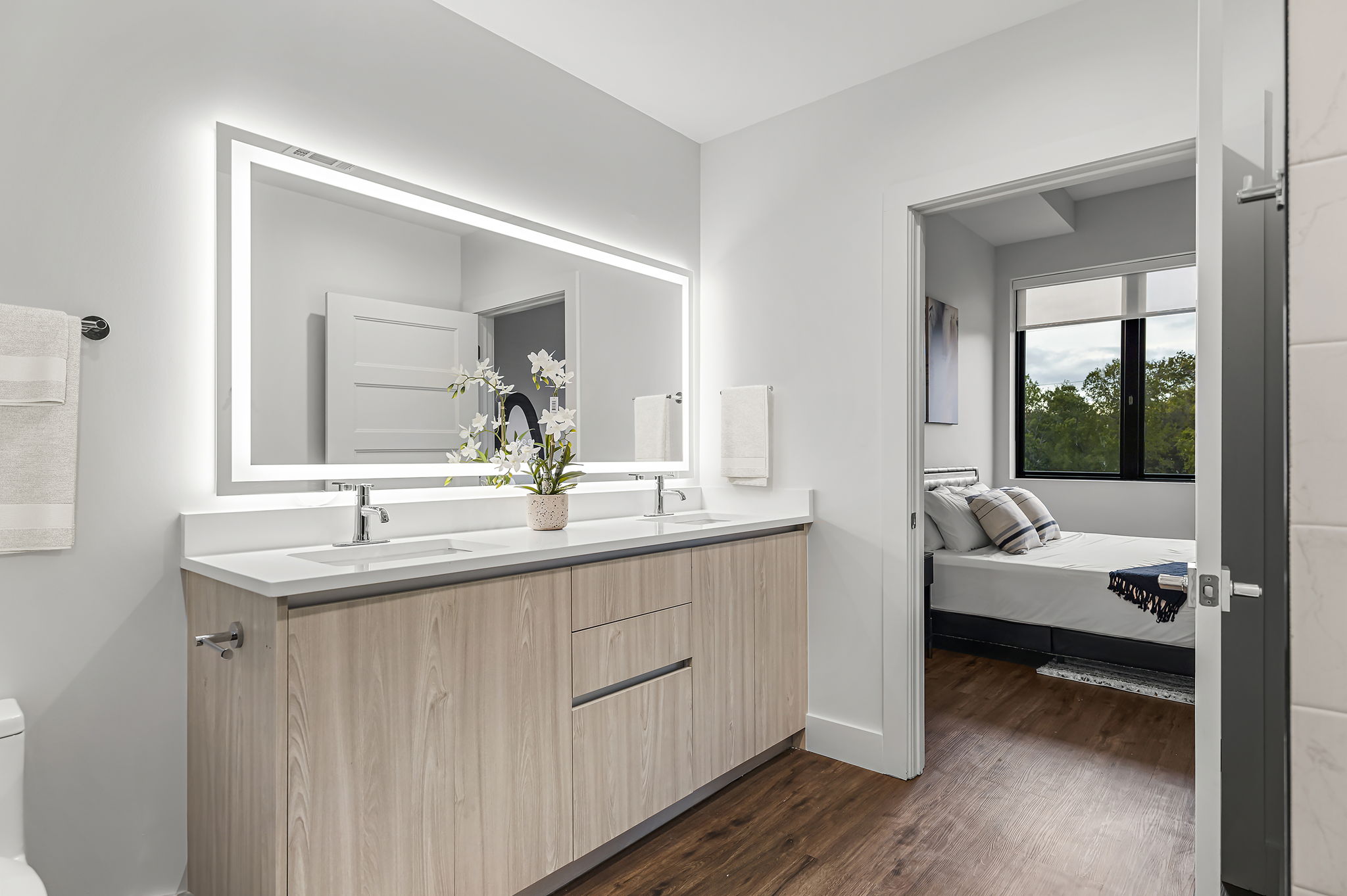 5515 Humming Bird Lane, Unit 309 Austin, TX 78745 - Photo 11 of 38 a en suite bathroom with a granite countertop sink and a mirror