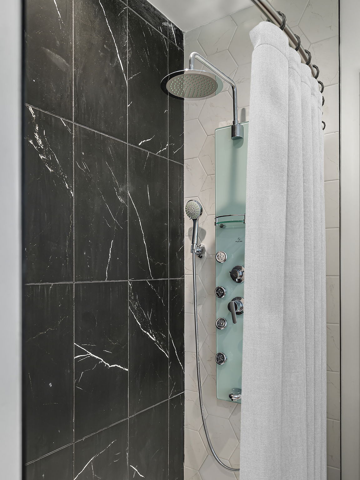 5515 Humming Bird Lane, Unit 309 Austin, TX 78745 - Photo 12 of 38 a bathroom with a shower and a mirror