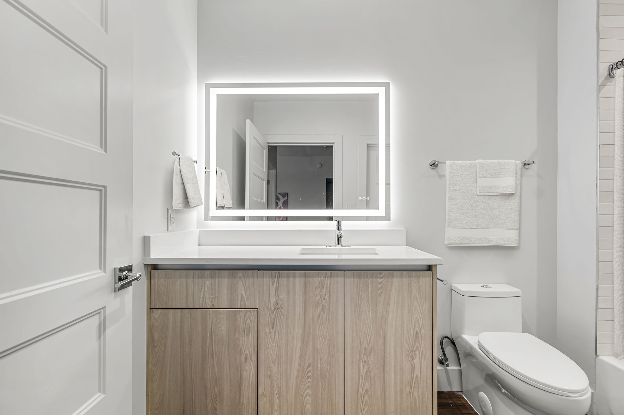 5515 Humming Bird Lane, Unit 309 Austin, TX 78745 - Photo 17 of 38 a bathroom with a sink a toilet a mirror and vanity