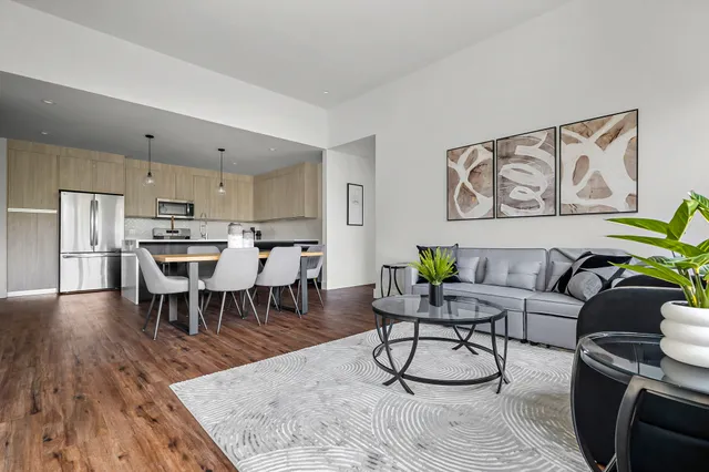 a living room with furniture and a wooden floor