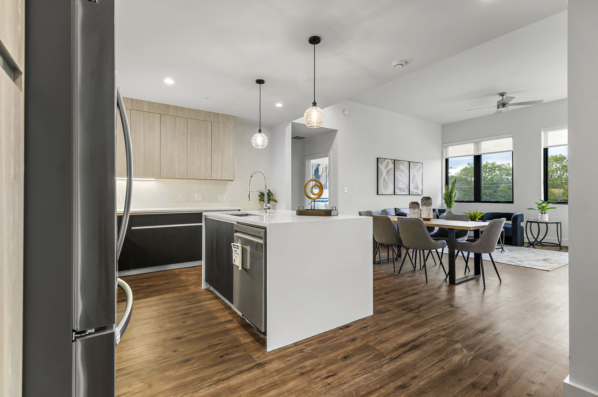 5515 Humming Bird Lane, Unit 309 Austin, TX 78745 - Photo 3 of 38 a kitchen with a table chairs refrigerator and cabinets