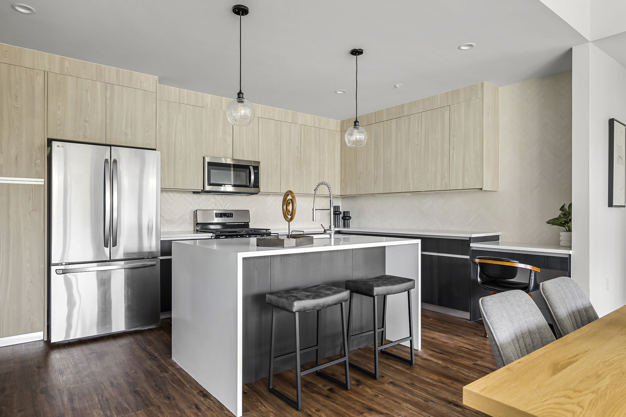5515 Humming Bird Lane, Unit 309 Austin, TX 78745 - Photo 6 of 38 a kitchen with stainless steel appliances a stove a refrigerator a sink a dining table and chairs