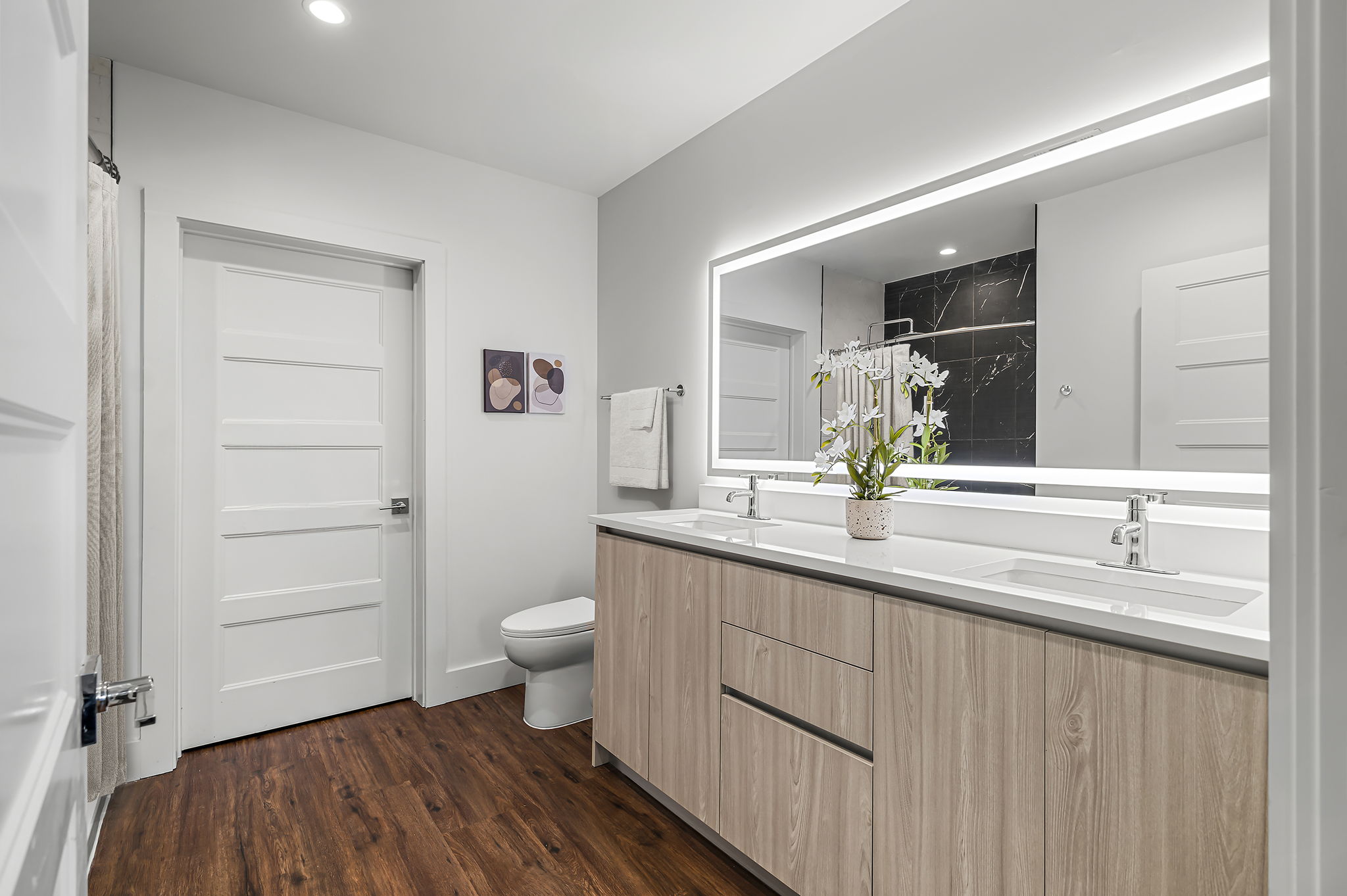 5515 Humming Bird Lane, Unit 309 Austin, TX 78745 - Photo 9 of 38 a bathroom with a sink a toilet and a large mirror