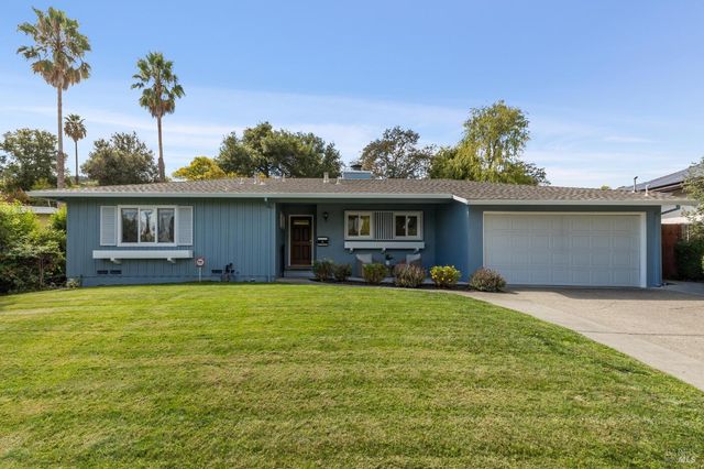 a front view of house with yard patio and green space