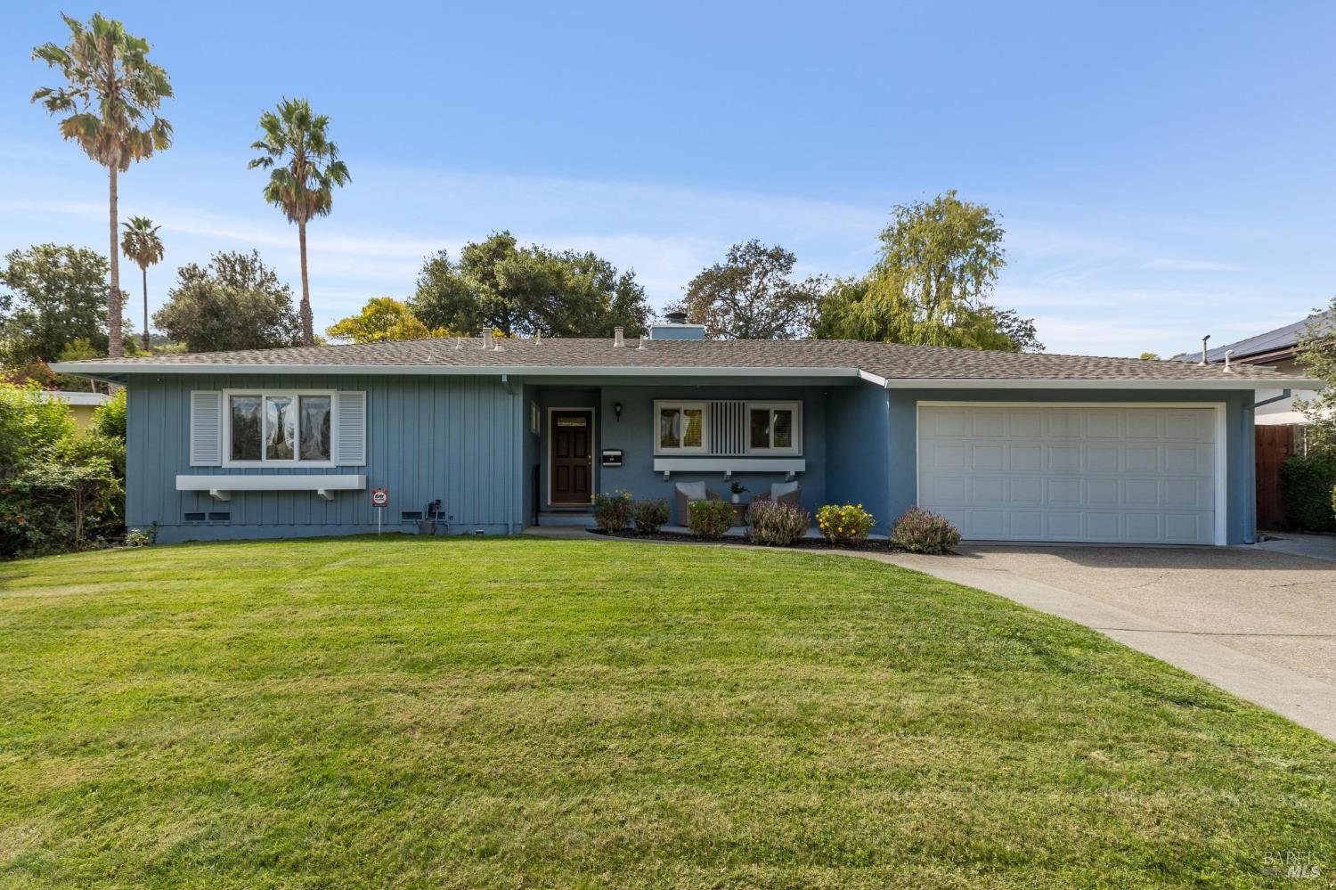 a front view of house with yard patio and green space