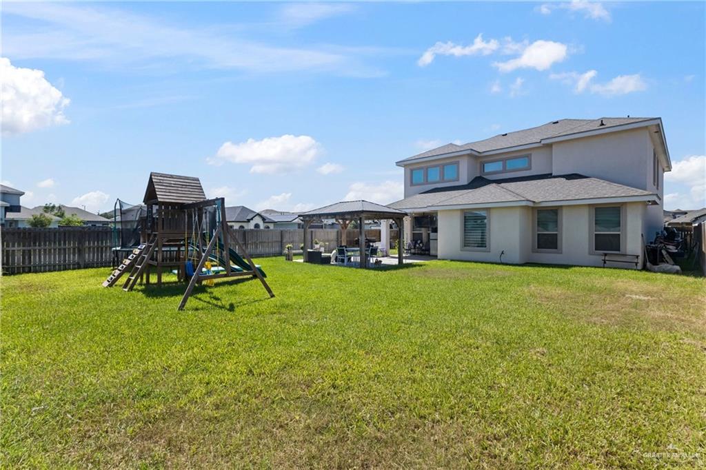 1904 Ridgeway Circle Edinburg, TX 78542 - Photo 27 of 32 Expansive backyard featuring a manicured lawn, a covered patio, and a built-in gazebo