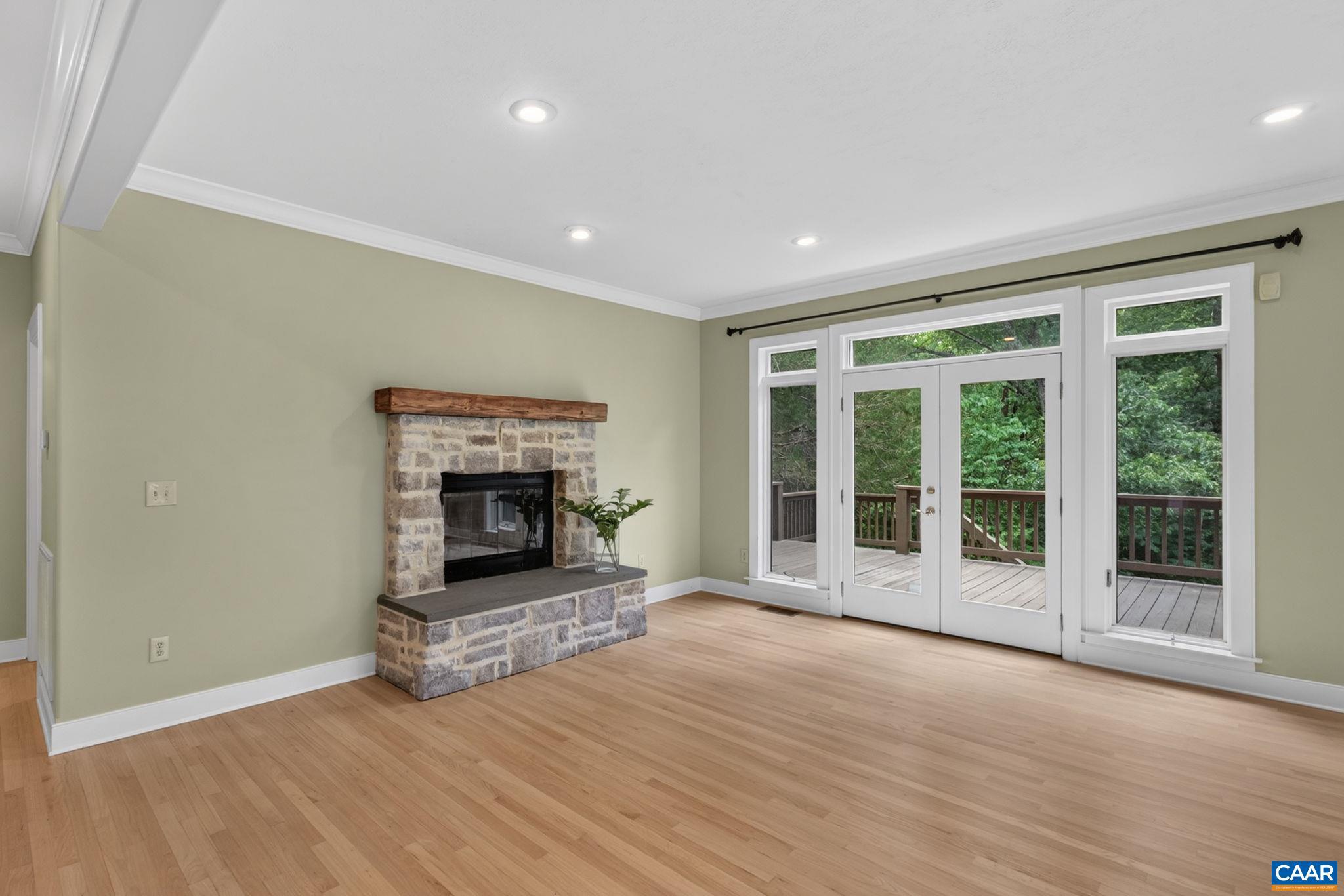 6285 Jarmans Gap Road Crozet, VA 22932 - Photo 10 of 65 a view of an empty room with wooden floor fireplace and a window