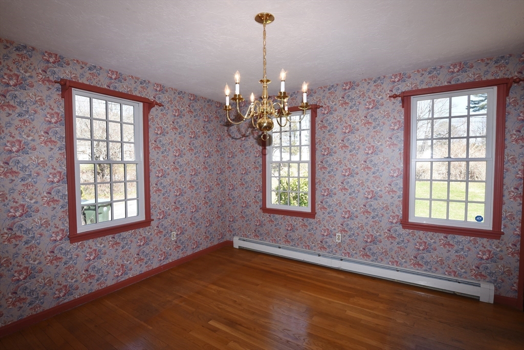 15 Furnace Street Marshfield, MA 02050 - Photo 21 of 41 an empty room with wooden floor chandelier and windows