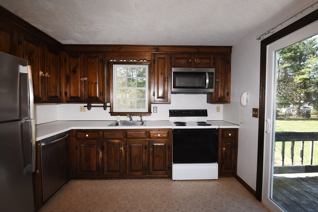 15 Furnace Street Marshfield, MA 02050 - Photo 24 of 41 a kitchen with a sink and a refrigerator