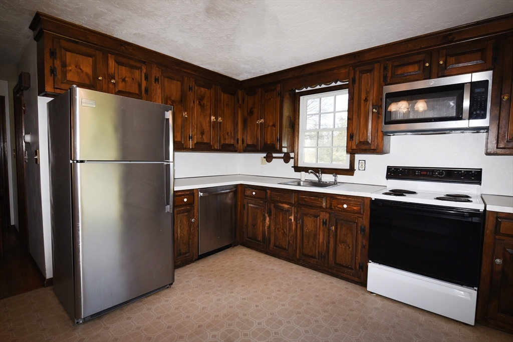 15 Furnace Street Marshfield, MA 02050 - Photo 25 of 41 a kitchen with a refrigerator stove and sink