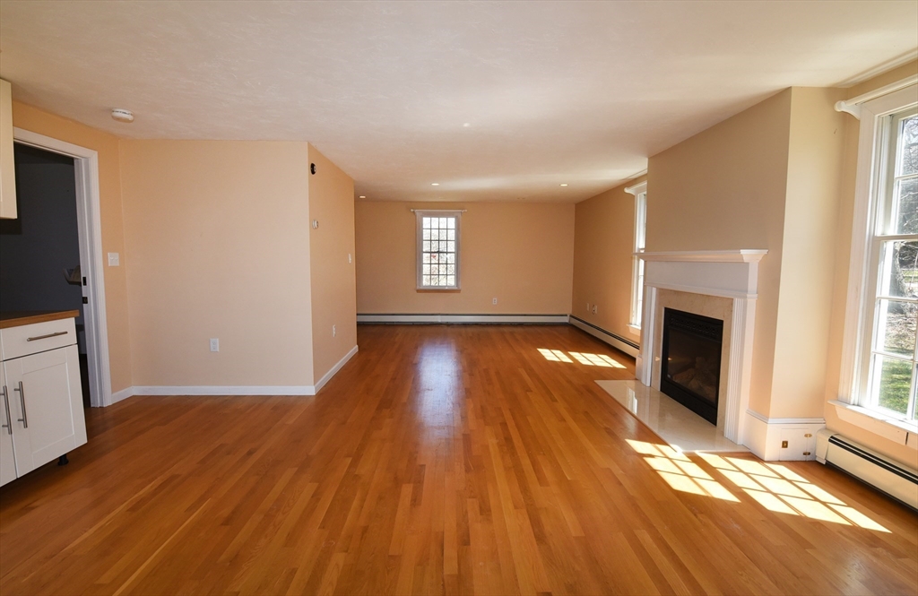 15 Furnace Street Marshfield, MA 02050 - Photo 3 of 41 a view of empty room with wooden floor and fireplace