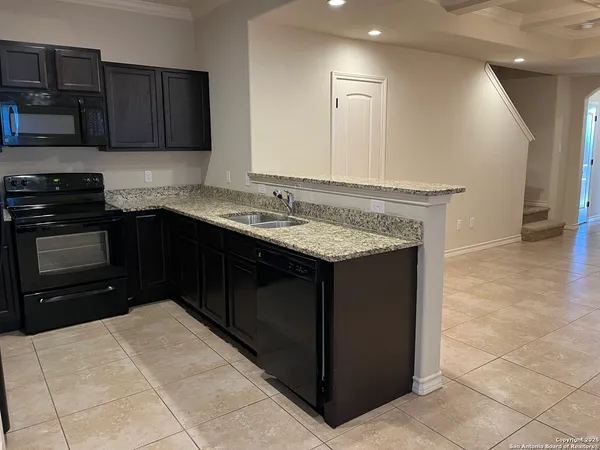 a kitchen with a sink and a stove top oven