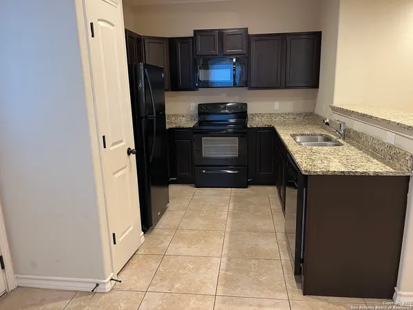 a kitchen with a refrigerator and a stove