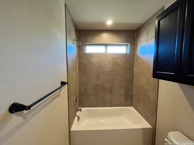 a bathroom with a bathtub and a shower