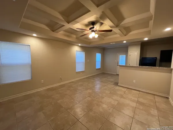 a view of an empty room with a kitchen