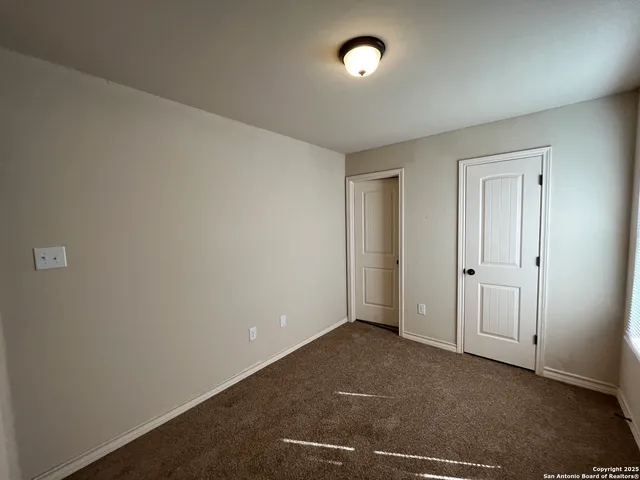 an empty room with closet area