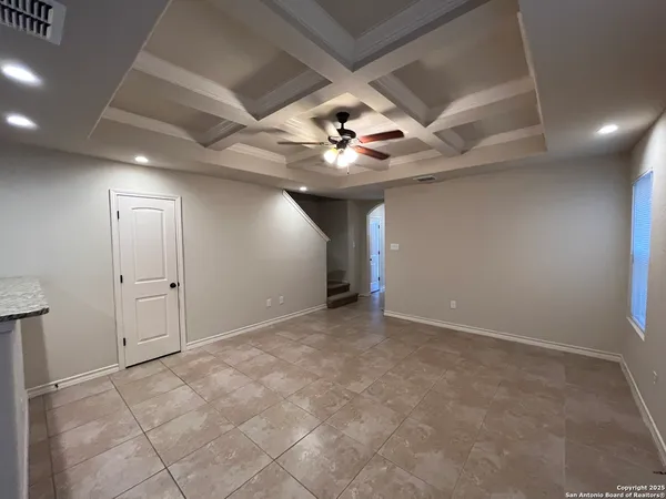 an empty room with fan and a ceiling fan