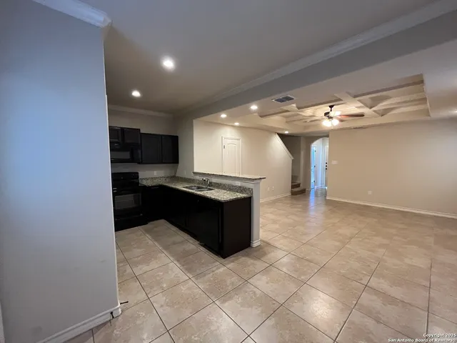 a kitchen with a sink a counter top space and appliances