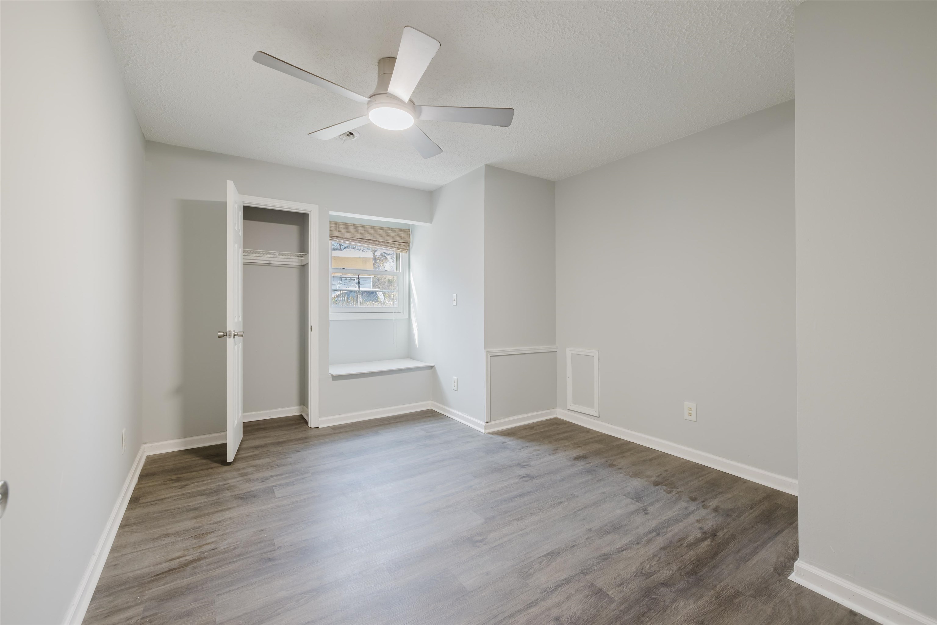 90 Freedom Way Myrtle Beach, SC 29577 - Photo 6 of 16 Unfurnished bedroom with a closet, wood finished floors, a ceiling fan, and a textured ceiling